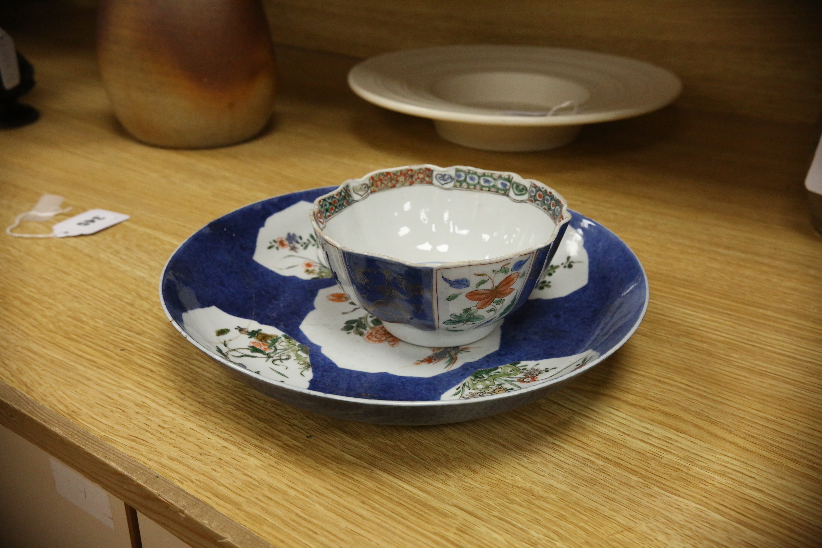 A Chinese famille verte powder blue ground bowl and a similar dish, both Kangxi period, 27.5cm diameter. Condition - dish poor, bowl fair